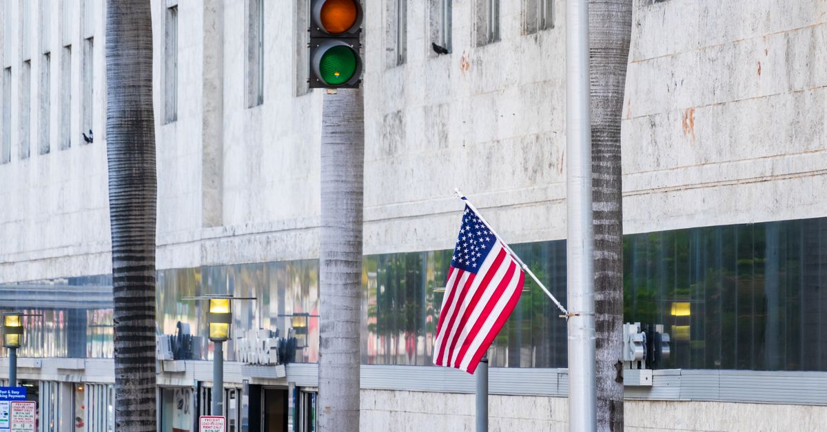 American flag flutters near traffic light on Lincoln Road in Miami Beach.