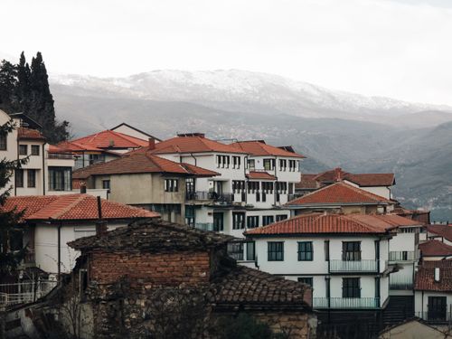 Free Traditional houses in Ohrid, North Macedonia with mountains in the background. Stock Photo