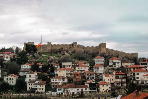 Free A scenic view of the medieval fortress in Ohrid, Macedonia with residential buildings in the foreground. Stock Photo