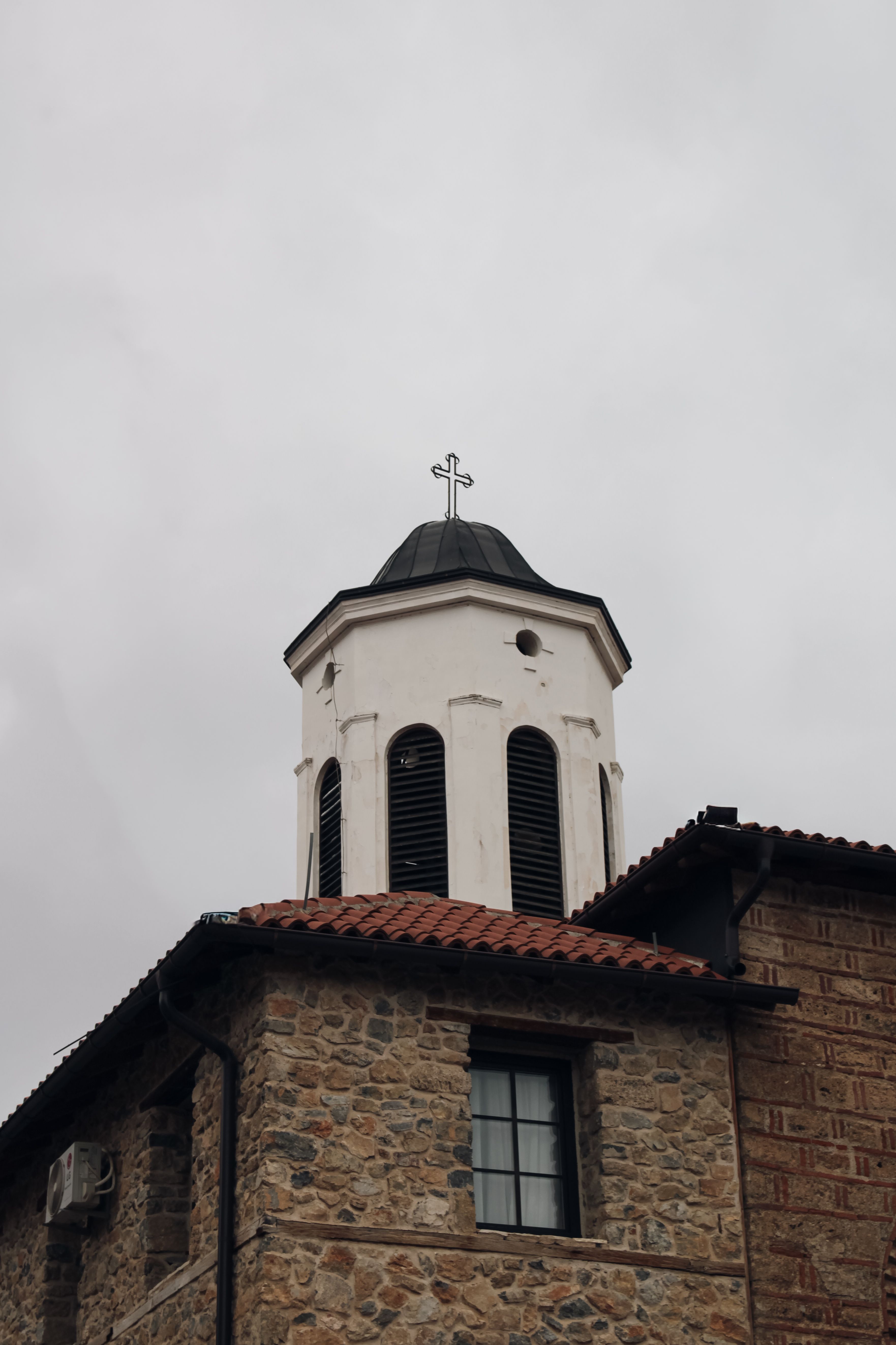 Rustic Church Bell Tower Against Cloudy Sky · Free Stock Photo