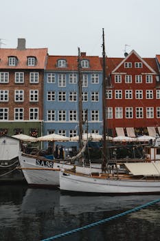Colorful houses and boats along Nyhavn canal in Copenhagen during winter.
