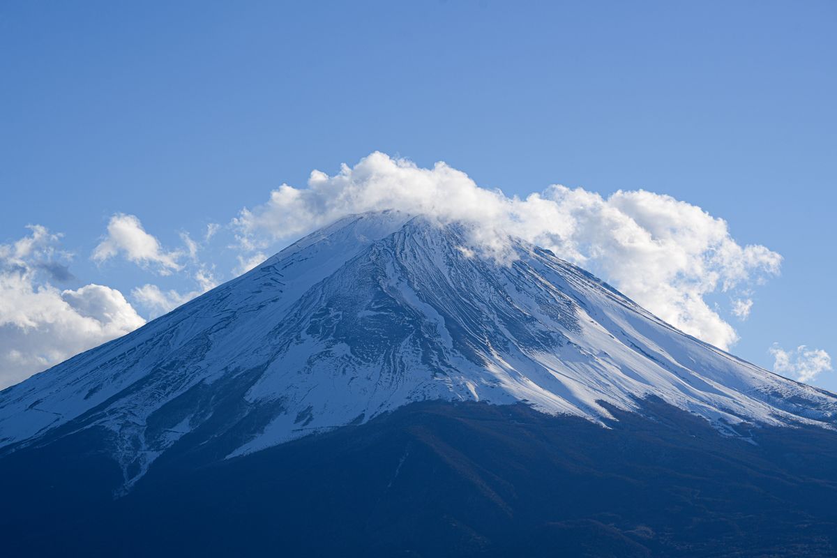 Serene view of snow-capped Mount Fuji under clear blue skies