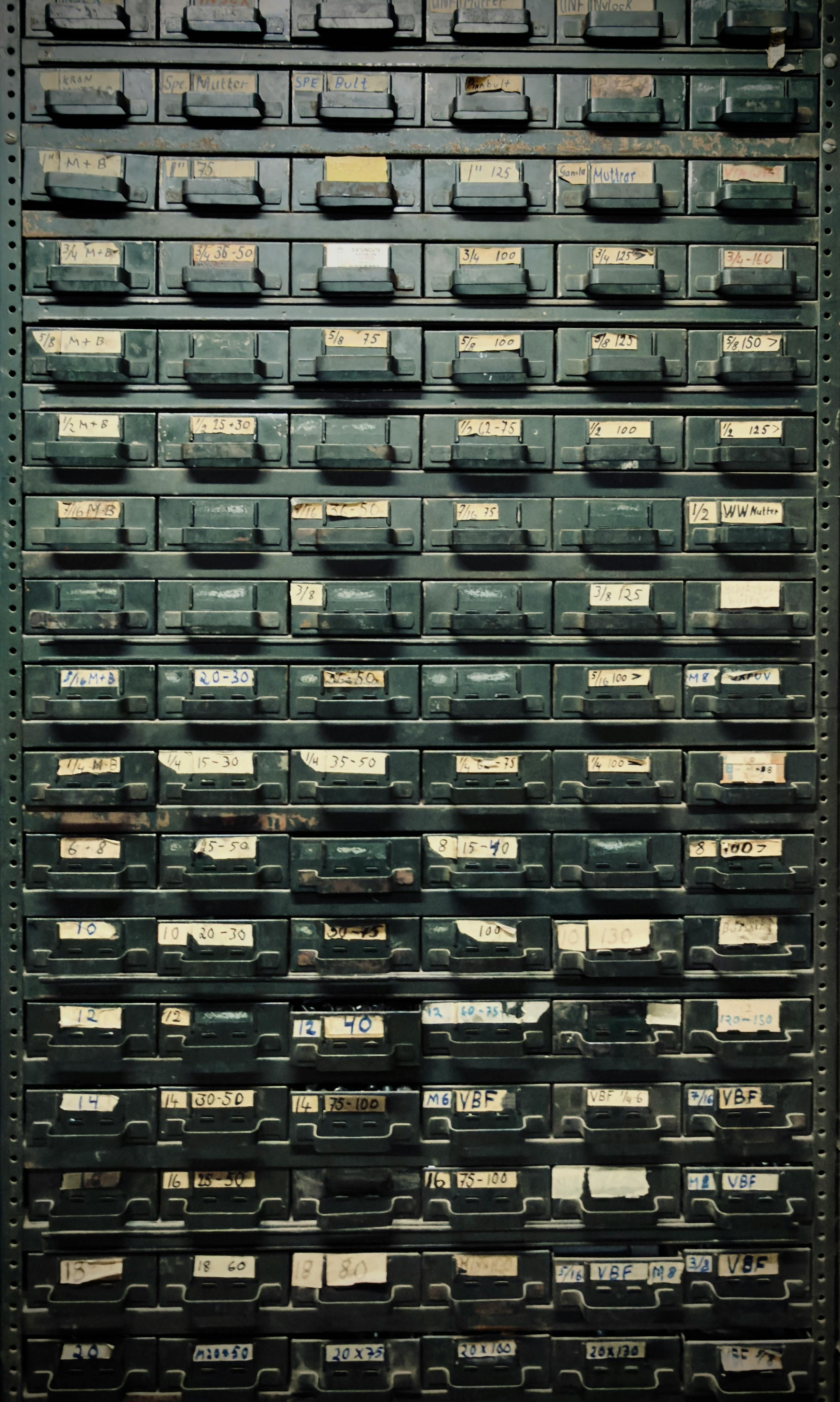 A vintage metal cabinet with labeled drawers, ideal for industrial-themed decor.