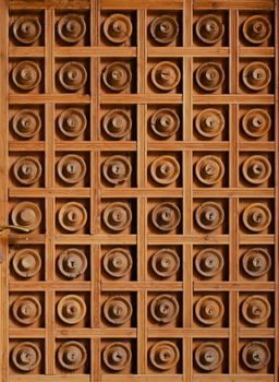 Intricate carved wooden door showcasing a geometric pattern and artisan craftsmanship in Barcelona.