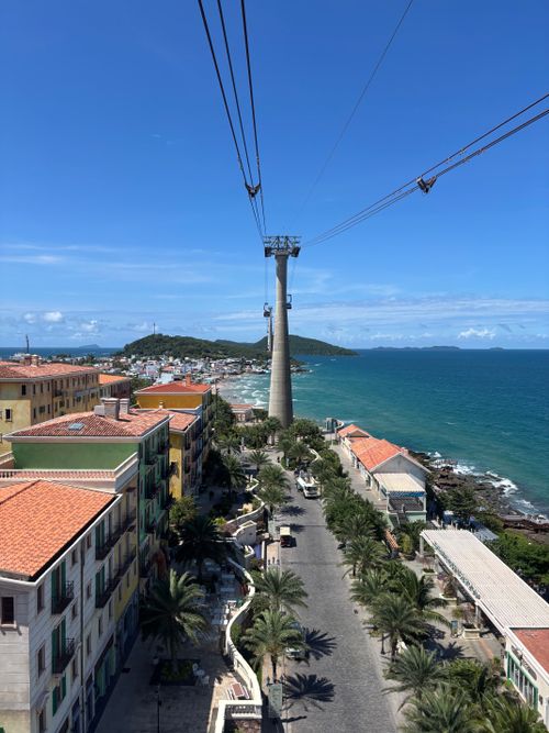 Free Stunning aerial view of a cable car journey over Phu Quoc, Vietnam, showcasing picturesque coastline and buildings. Stock Photo