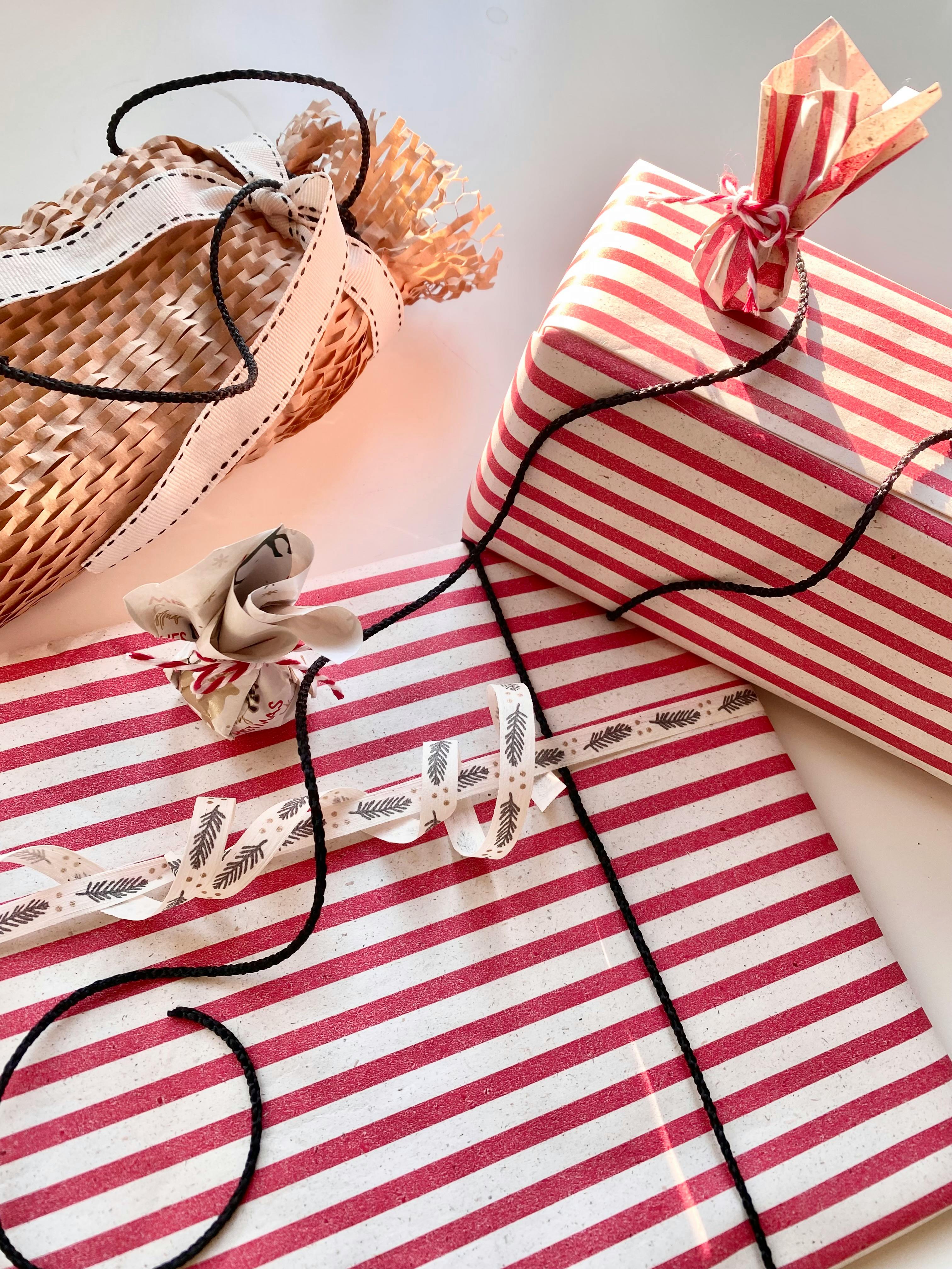 Elegantly wrapped gifts with striped paper and creative ribbons, perfect for festive occasions.
