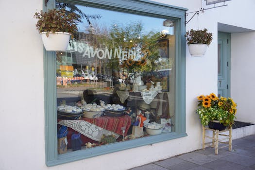 Colorful soap shop window display with sunflowers and reflections on a sunny day.