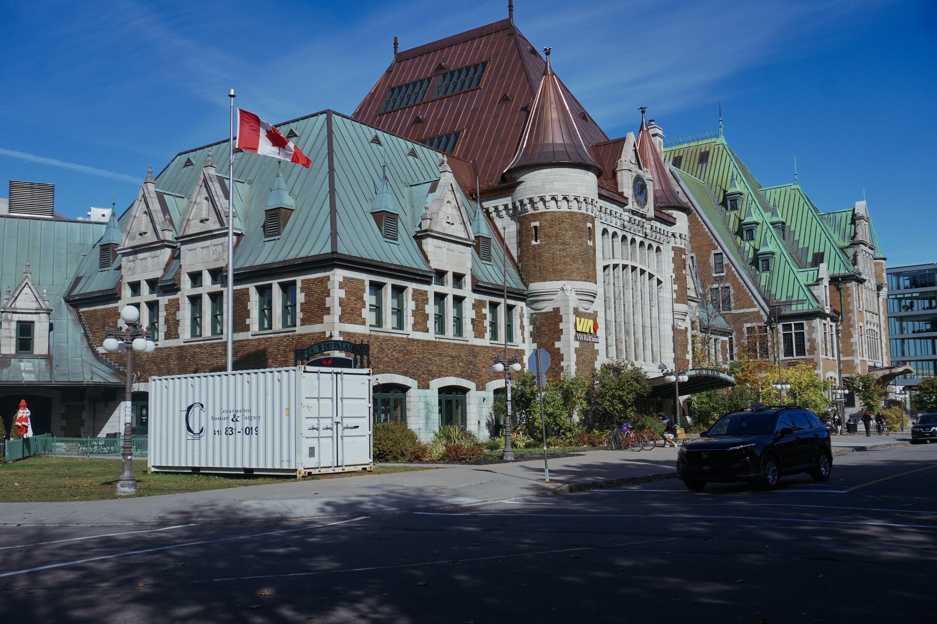 Historic Quebec building with Canadian flag under clear blue sky.