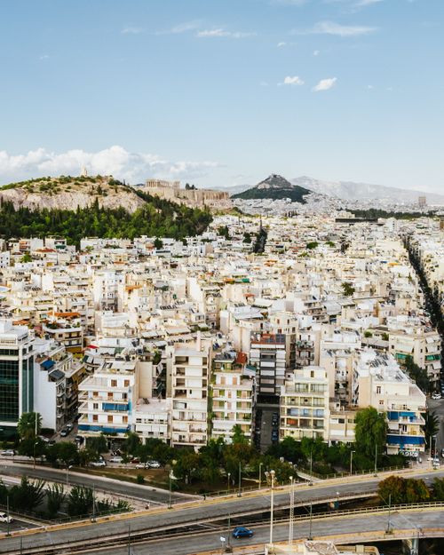 Free A stunning aerial view of Athens showcasing the Acropolis and urban landscape under a clear blue sky. Stock Photo