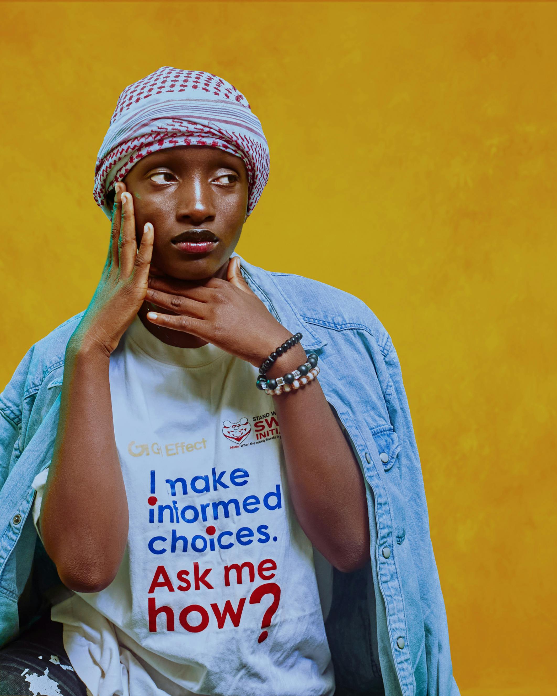 A stylish young adult posing in casual fashion against a vibrant backdrop, highlighting personal style.