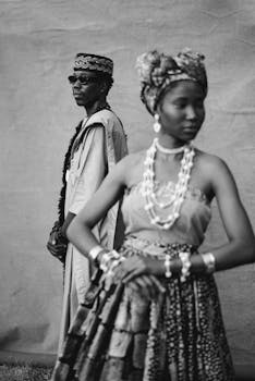 Black and white photo of a Nigerian couple in traditional attire, showcasing cultural elegance.