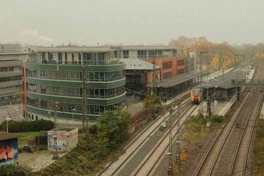 Aerial view of a railway station with modern office buildings in Mainz, Germany.