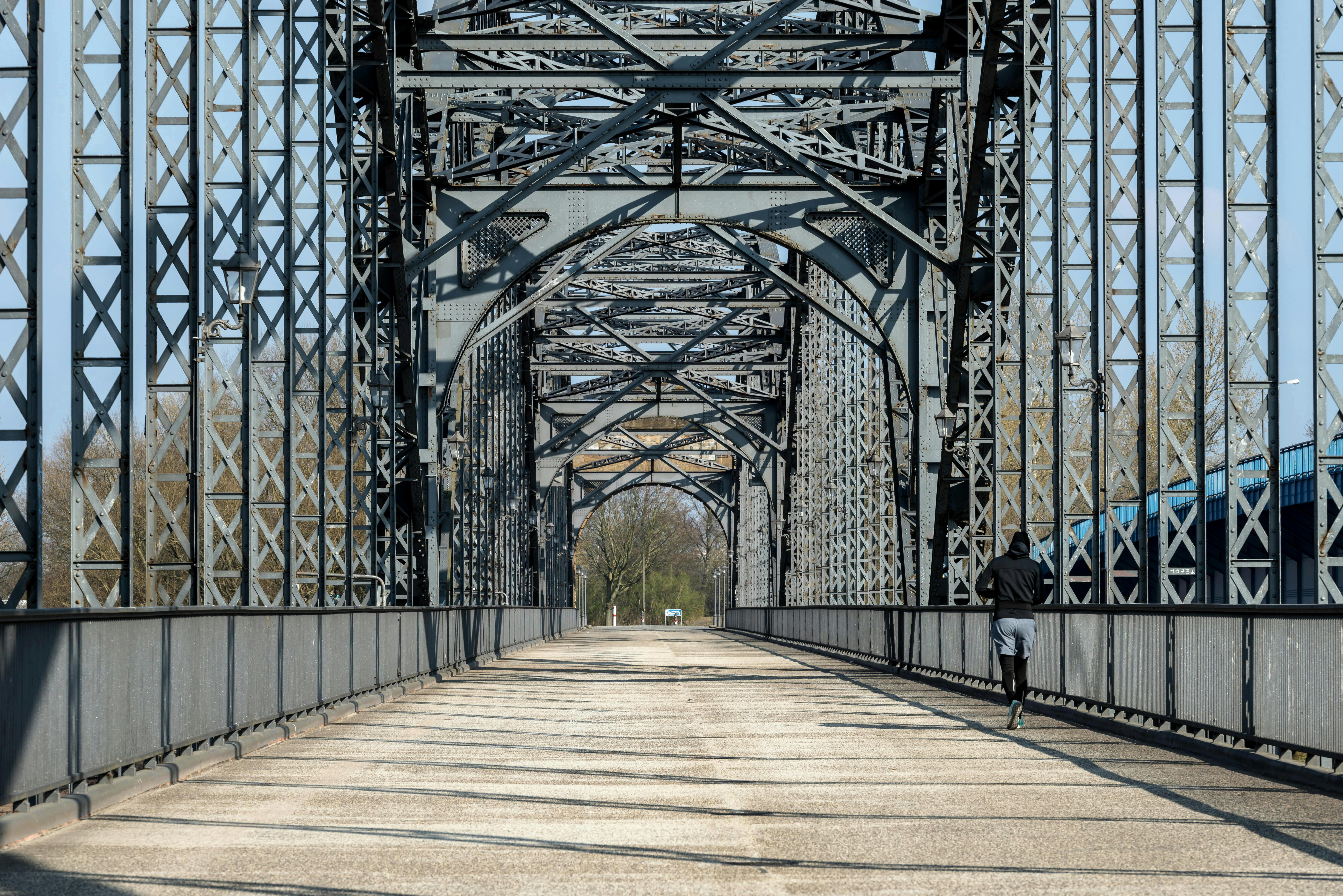 Runner exercising on an iconic steel arch bridge in Hamburg, Germany.