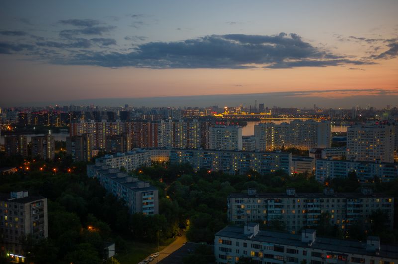 A stunning view of a city skyline at dusk with vibrant lights reflecting on the water