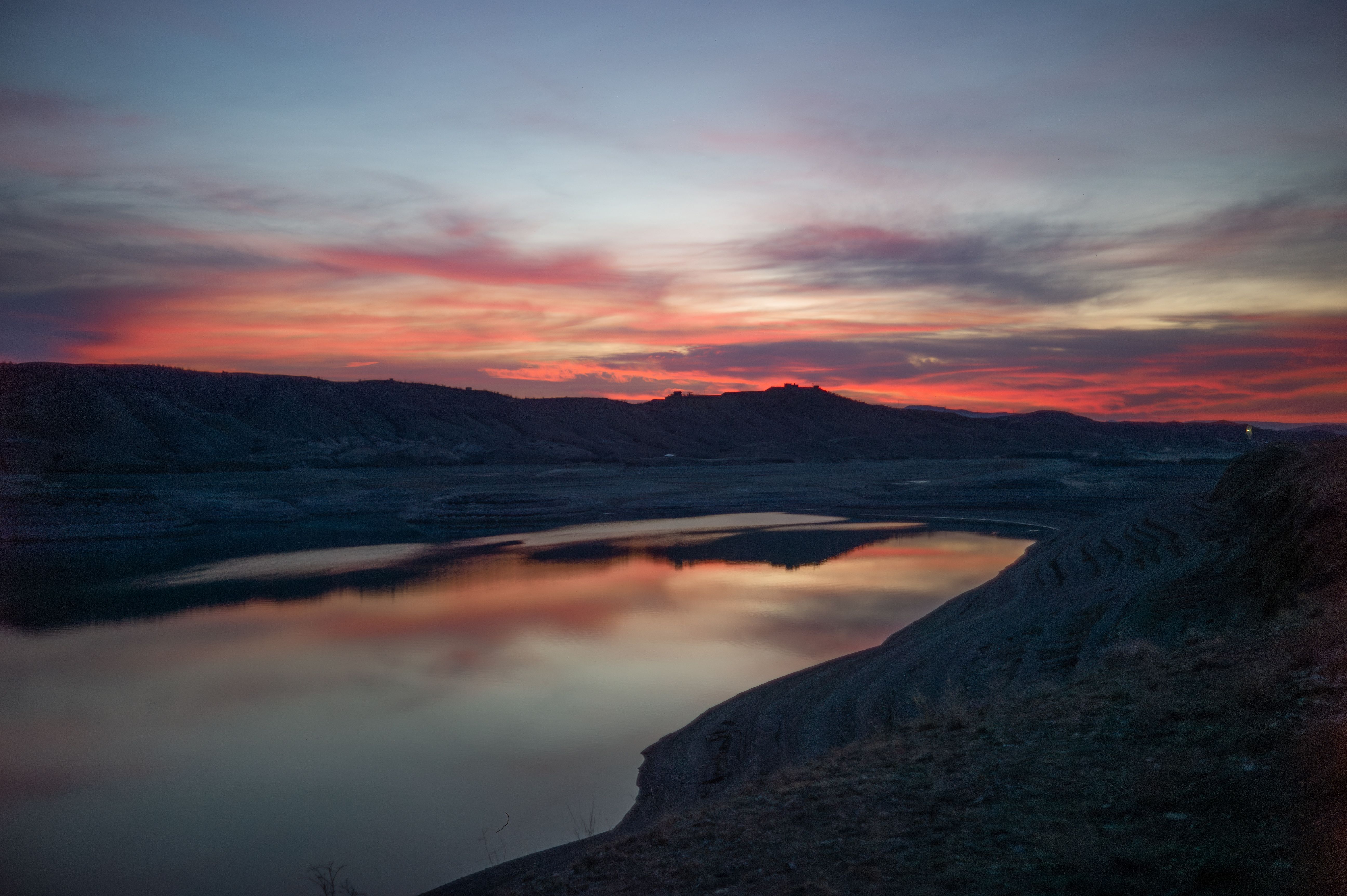 Serene sunset over a reflective lake · Free Stock Photo
