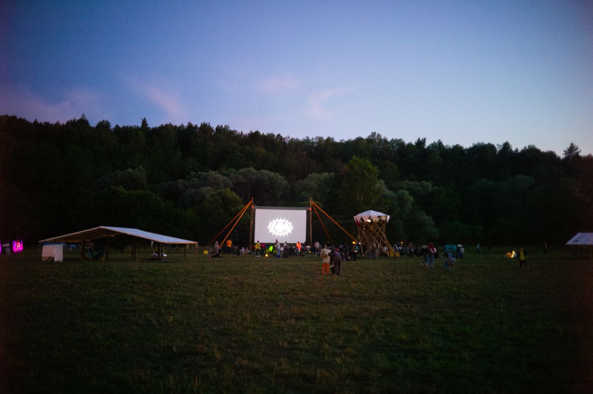 Magical outdoor evening movie screening in a forested country setting