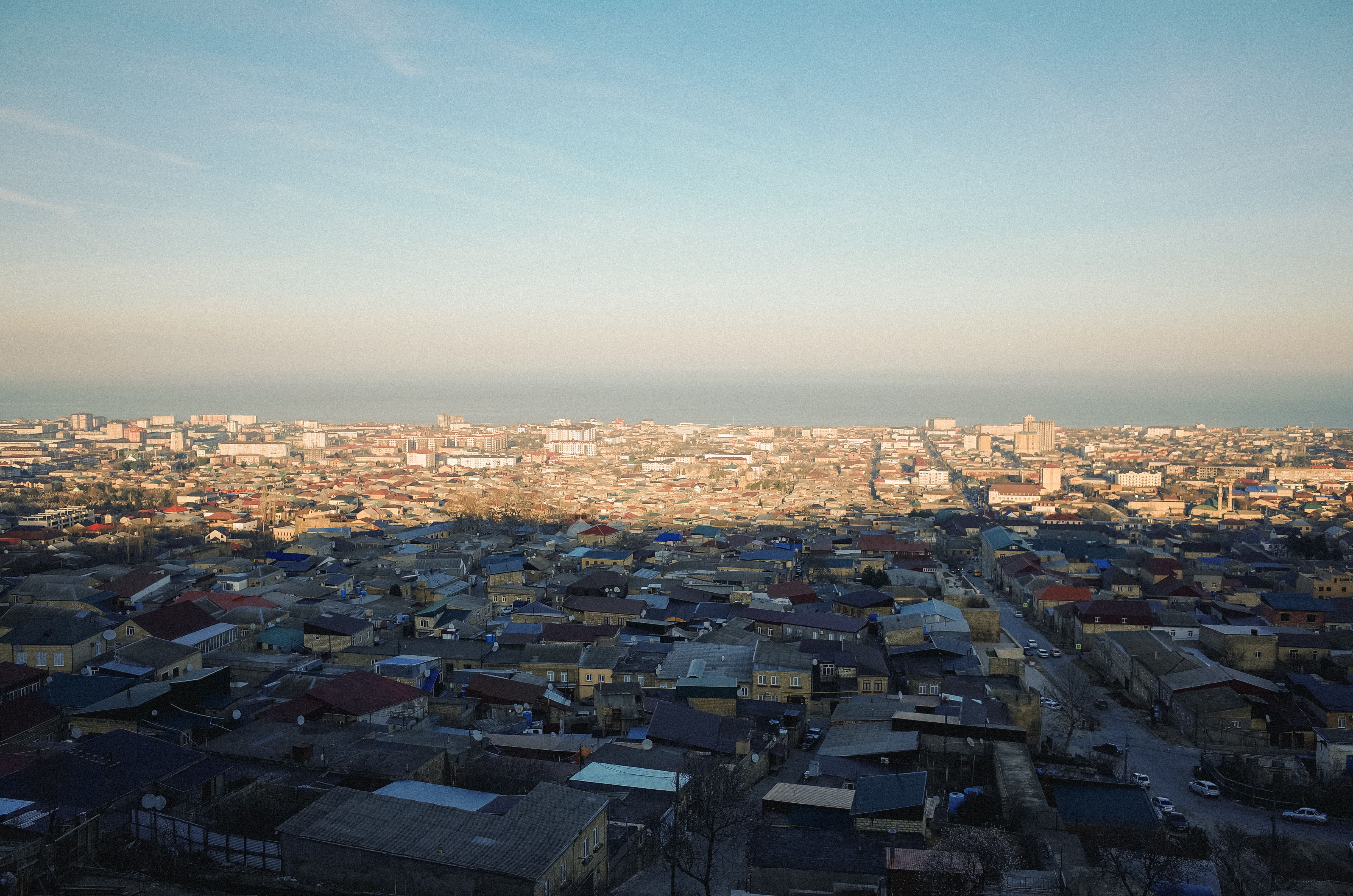 Aerial View of Urban Cityscape and Ocean Horizon · Free Stock Photo