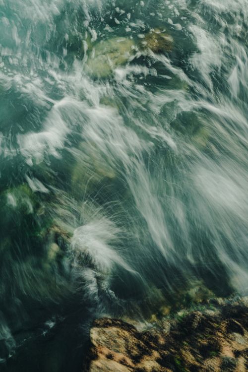 Free Abstract image of ocean waves crashing onto rocks with a long exposure effect. Stock Photo