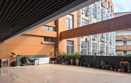 Modern urban terrace with plants and architecture details, ideal for lifestyle and design themes.