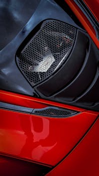 Detailed view of a red sports car engine showcasing luxury and design. Perfect for automotive enthusiasts.