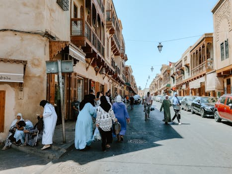 Capture of daily life in the colorful streets of Fes Medina, Morocco, showcasing traditional Moroccan architecture.