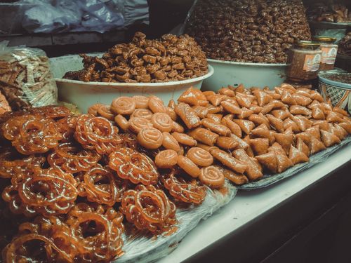 Free A variety of traditional Moroccan sweets displayed at a market in Fes, Morocco, showcasing local culinary culture. Stock Photo