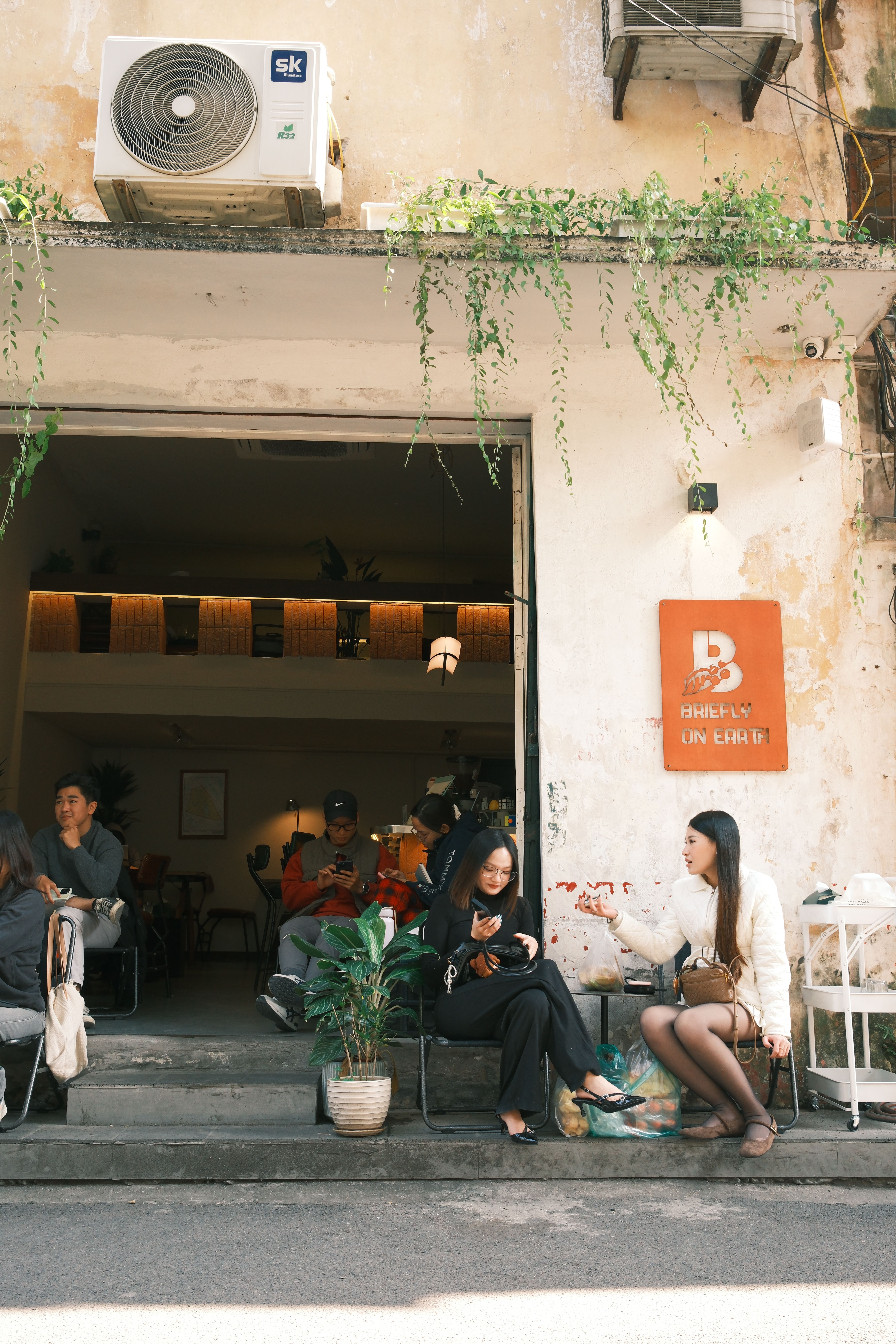 Casual outdoor scene in a Jamaican cafe with people socializing and enjoying a relaxed moment.