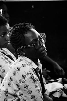 A focused group of students attentively listens in a classroom setting.