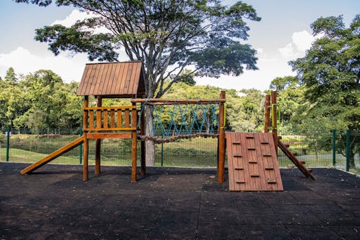 Outdoor wooden playground equipment in a lush park setting in Londrina, Brazil.