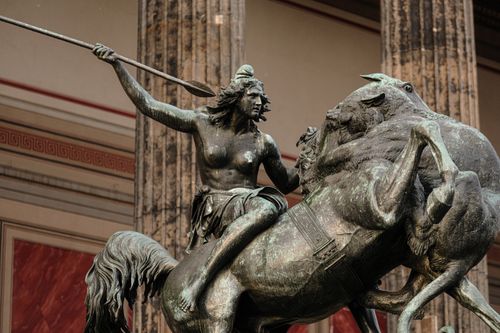 Free Striking bronze statue depicting a warrior with a spear and a horse. Captivating indoor museum art. Stock Photo