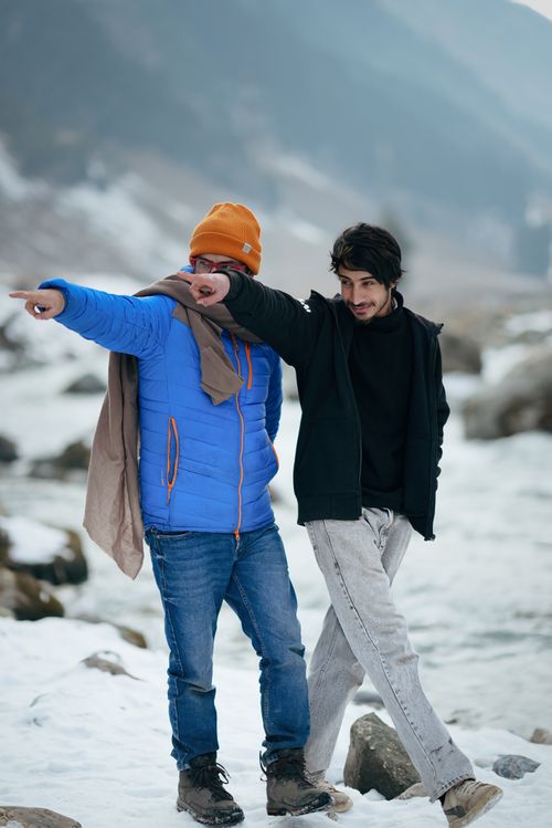 Free Two friends exploring the snowy landscapes of Jammu and Kashmir, capturing the essence of winter adventure. Stock Photo