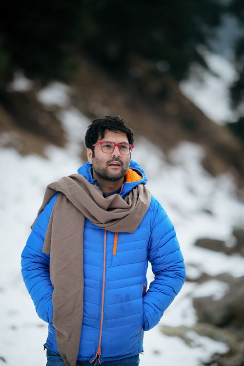 Free A man in a blue jacket with glasses stands outdoors in a snowy setting in Jammu and Kashmir. Stock Photo