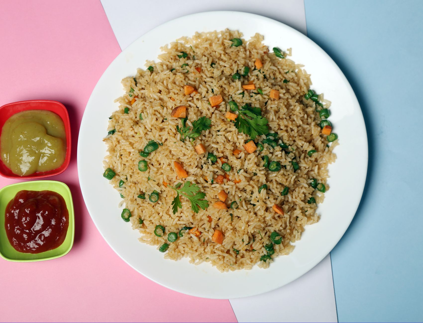 Fried rice with peas and carrots in wok