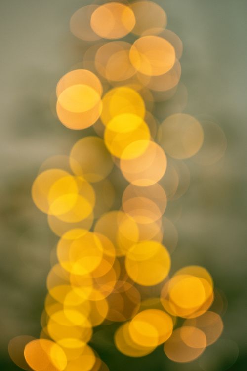 Free Soft focus image of abstract golden bokeh lights creating a warm and festive mood. Stock Photo