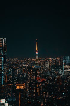 A breathtaking view of Tokyo's vibrant cityscape highlighting the illuminated Tokyo Tower at night.