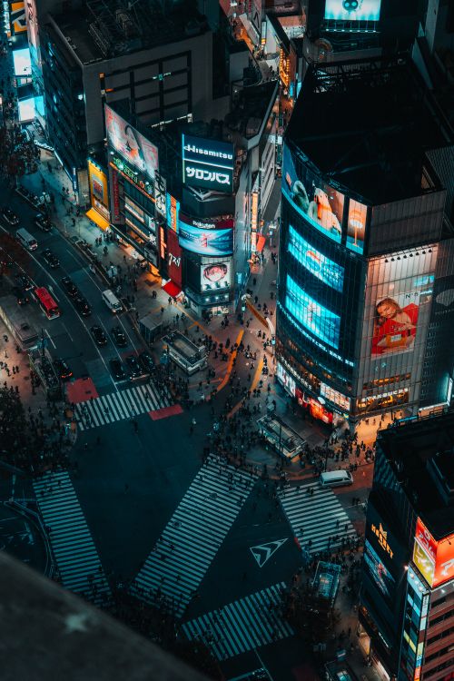 Free Dynamic night view of bustling Shibuya Crossing in Tokyo, Japan. Vibrant city life captured from above. Stock Photo