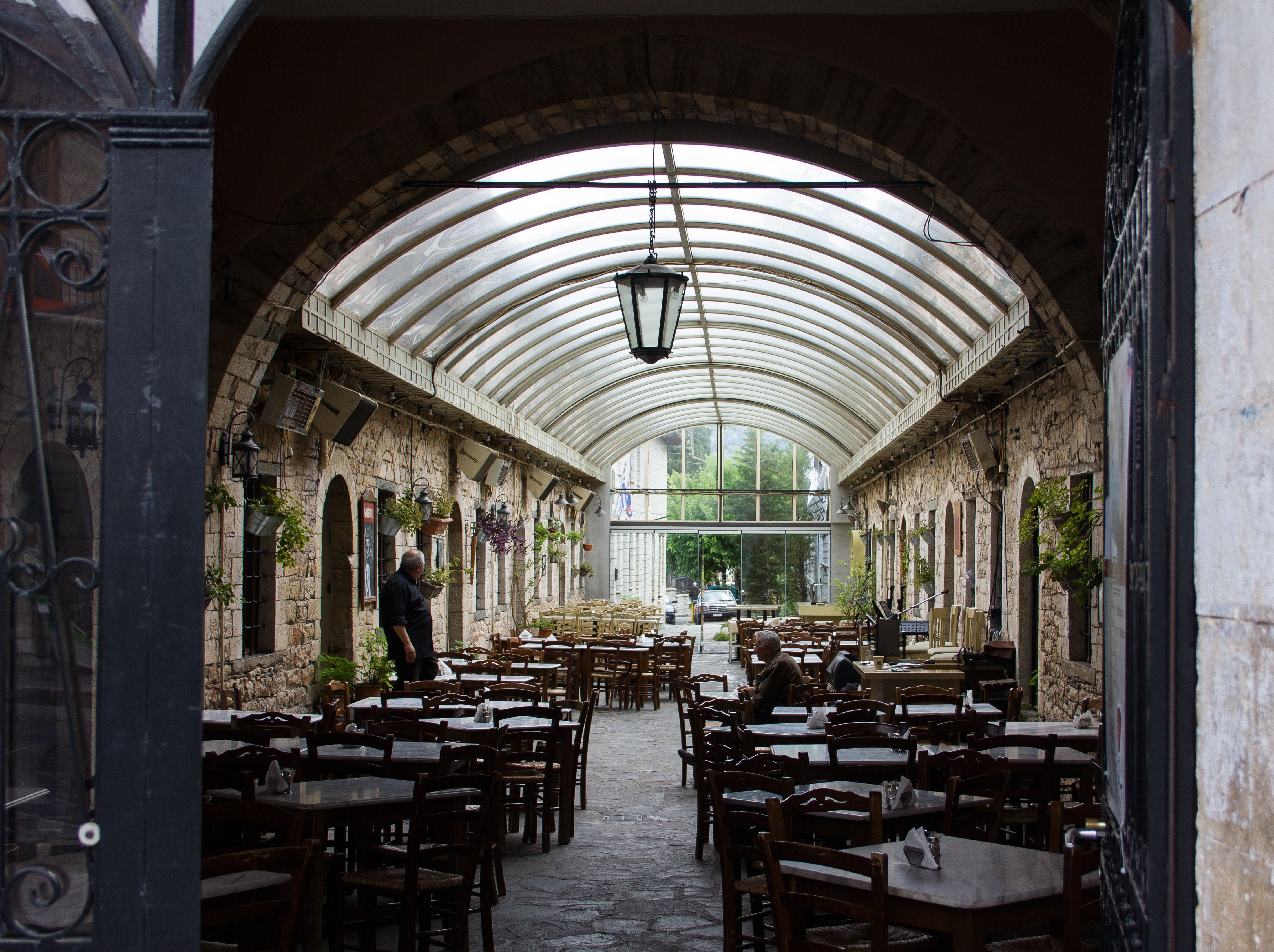 Rustic Indoor Courtyard Café with Stone Architecture · Free Stock Photo