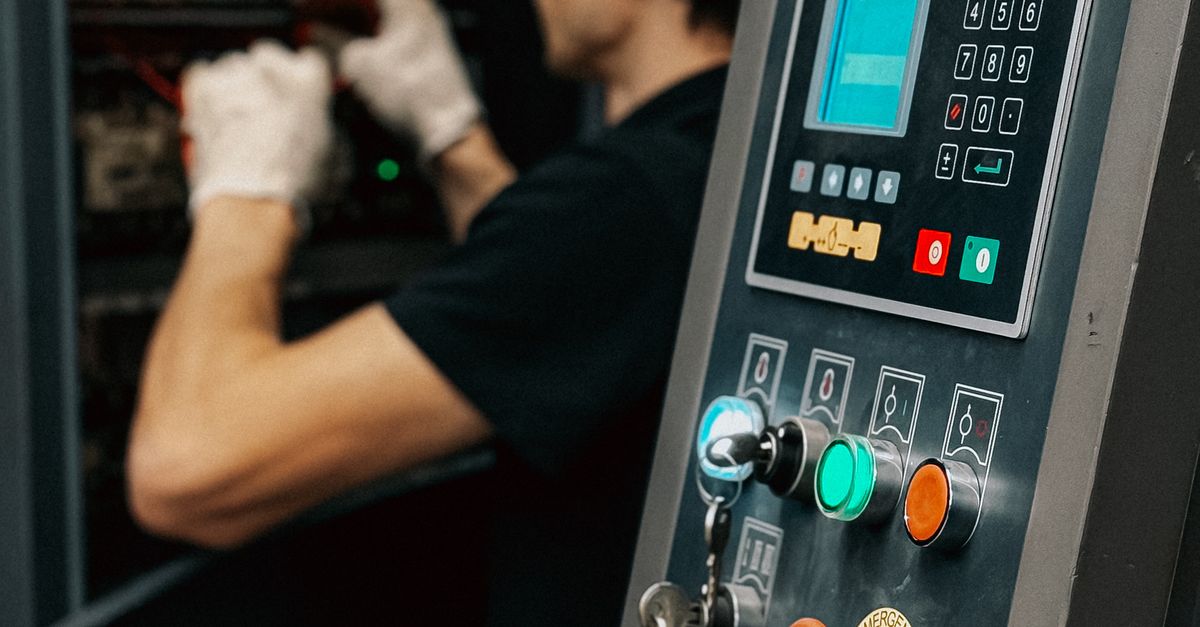 Industrial Worker Operating Machinery Control Panel · Free Stock Photo