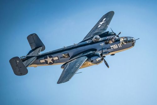 Free A North American B-25 Mitchell bomber aircraft flying against a clear blue sky in San Diego. Stock Photo