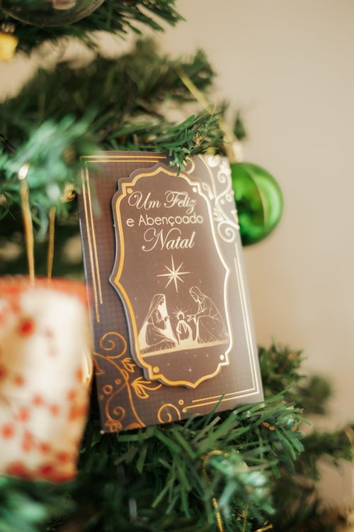 Free Close-up of a Christmas tree featuring a nativity card with festive decorations in a cozy ambiance. Stock Photo