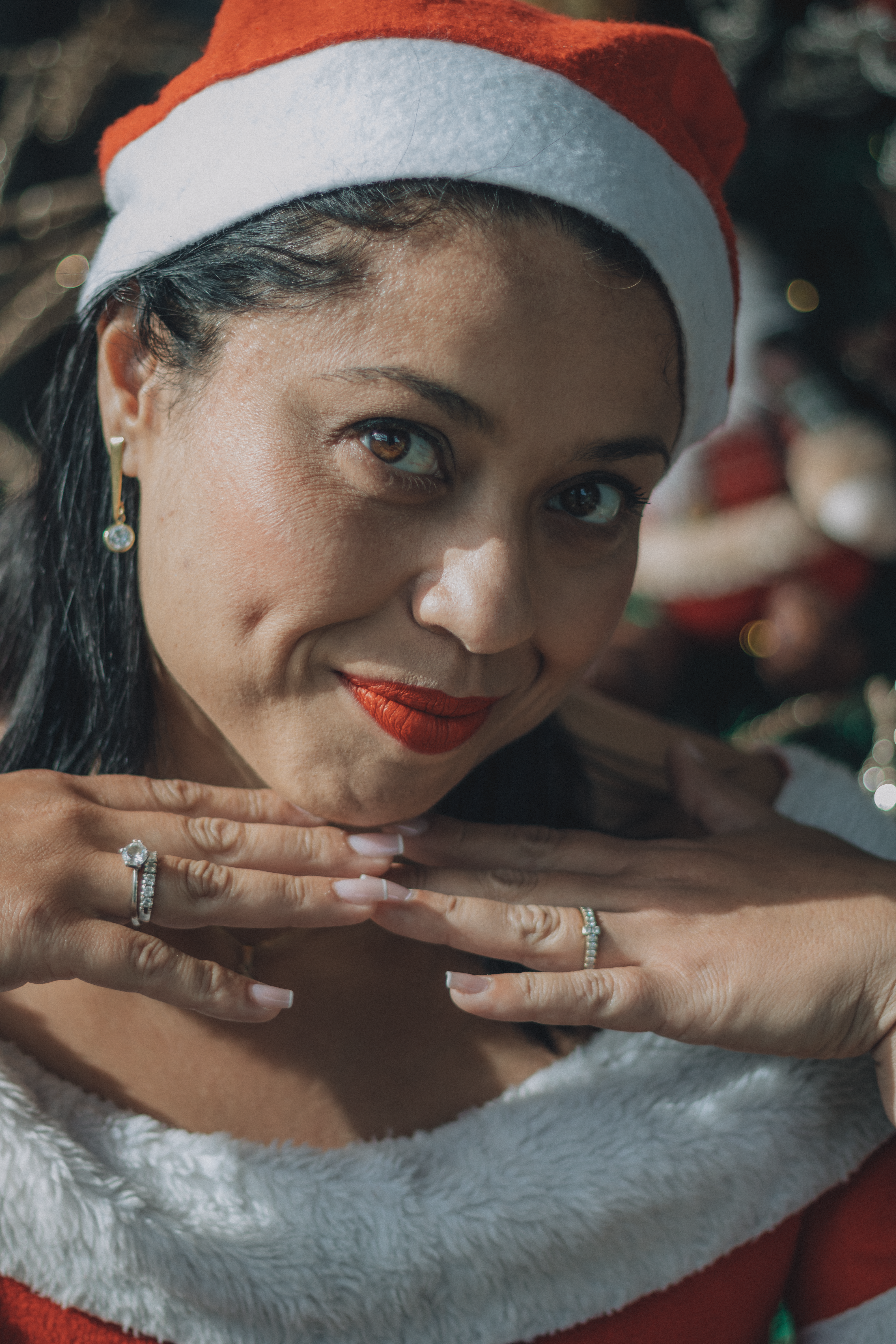 Festive Woman in Santa Hat Celebrating Holidays · Free Stock Photo