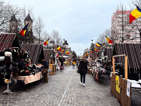 Street market with stalls and flags, lively winter scene.