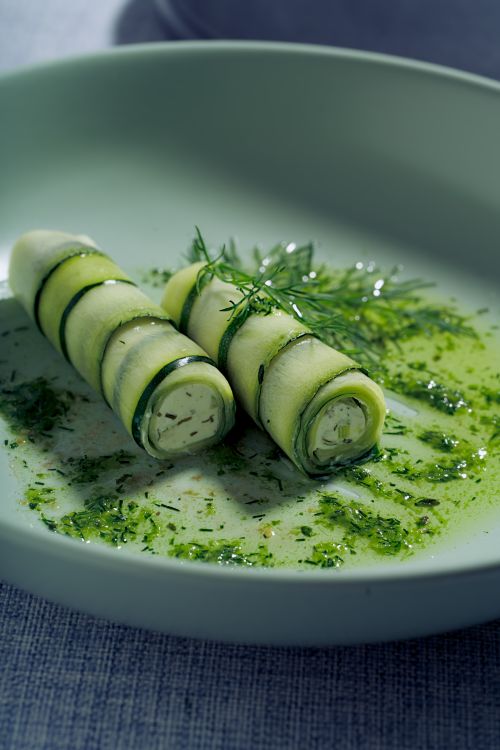 Free Elegant zucchini rolls garnished with fresh herbs on a plate. Stock Photo
