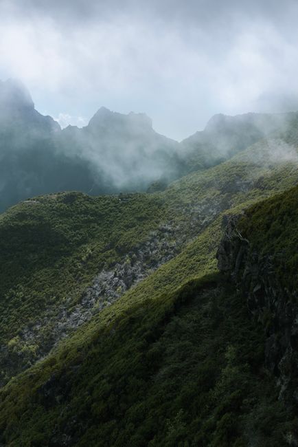 Scenic misty mountains in Madeira, Portugal showcasing lush greenery and rugged terrain.