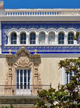 Stunning Andalusian building facade with intricate tiles and classic arches.