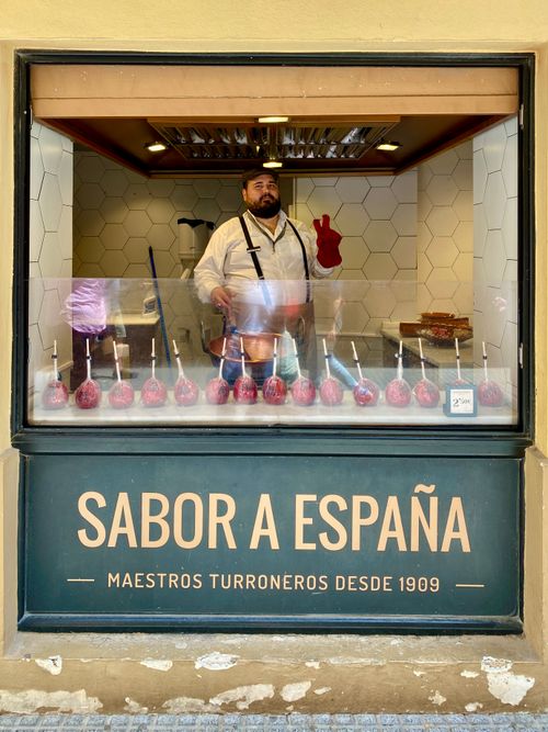 Free A man prepares candied apples in a Spanish shop window display. Stock Photo