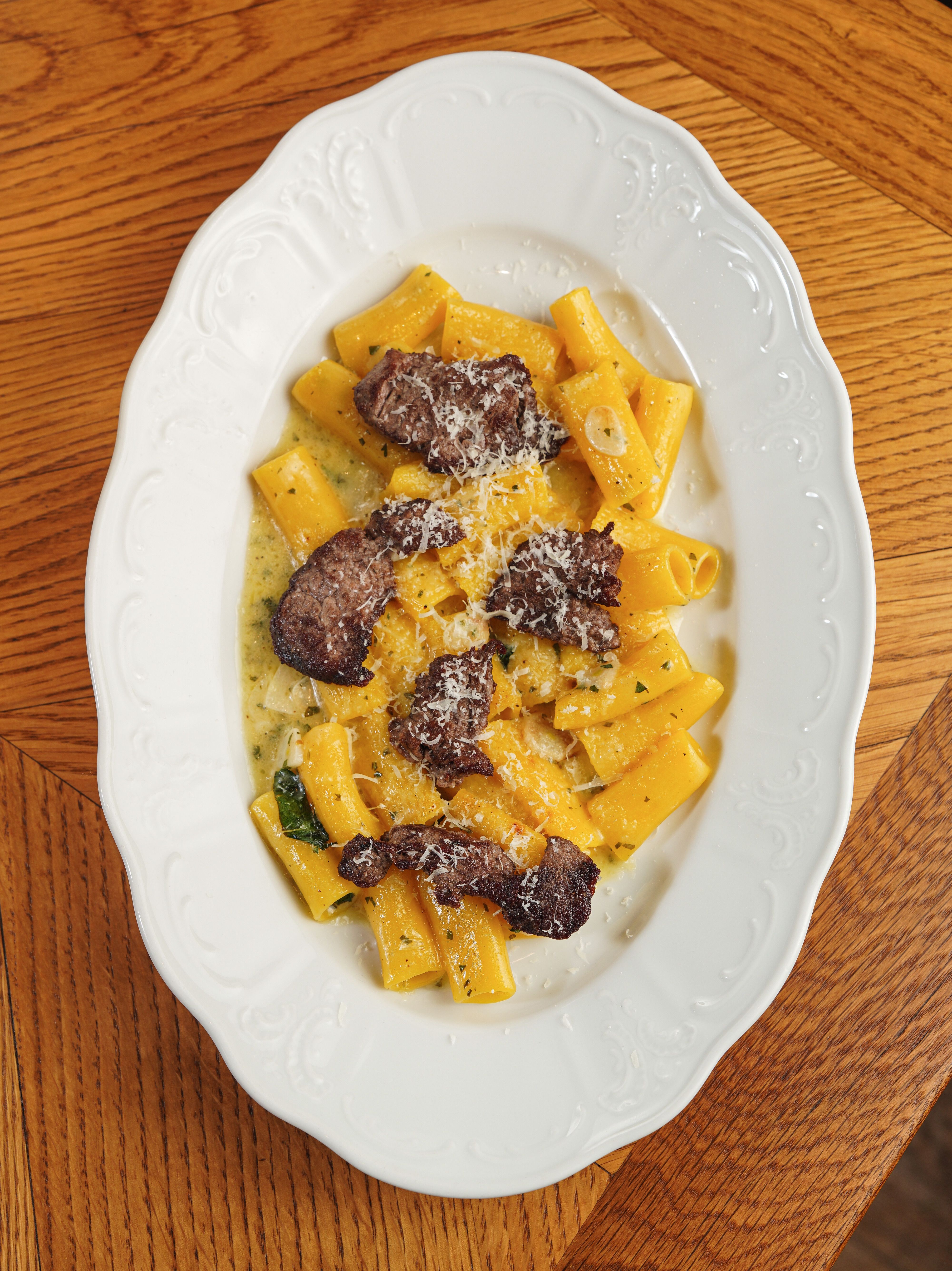Seared beef strips with pasta in a creamy Parmesan sauce