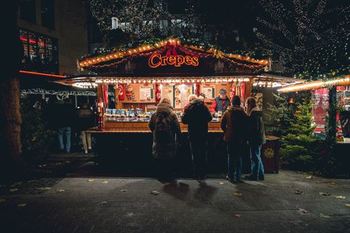 Free Illuminated crepes stall at a bustling Christmas market in Germany. Stock Photo