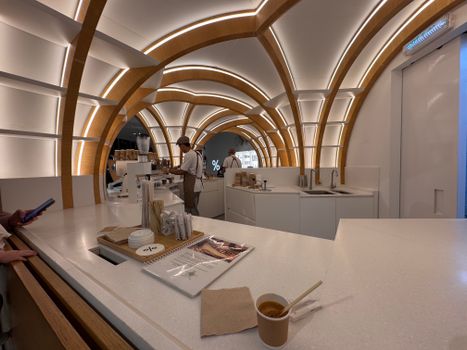 Contemporary cafe interior featuring striking wooden arches and sleek design.