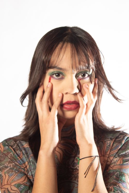 Free Close-up portrait of a person with artistic makeup expressing emotion. Stock Photo
